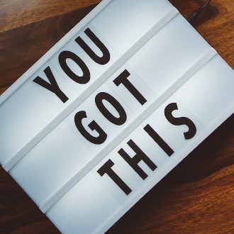 Marquee-like sign on a desktop that says "YOU GOT THIS"