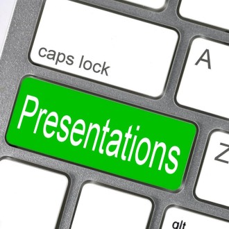 Closeup image of a keyboard; one of the keys is green and says "Presentations"