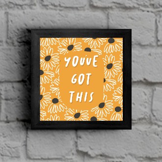 Yellow and black art print on a brick wall that says you got this