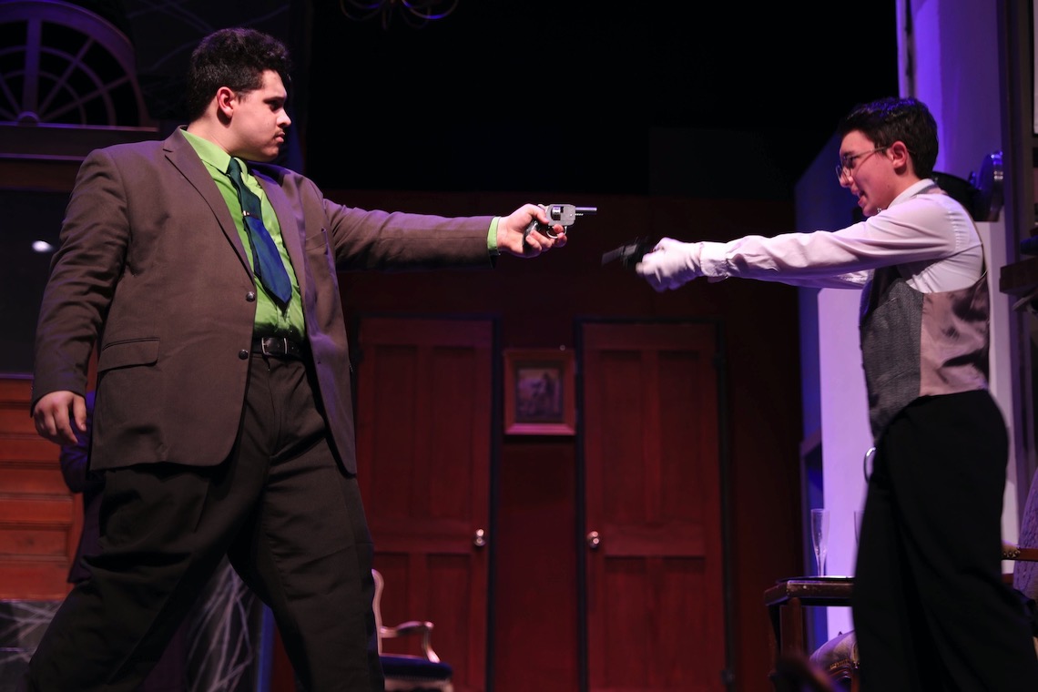 Mr. Green (Ryan Kohnert) and Wadsworth (Atticus Watson) take aim at each other in Clue: On Stage.