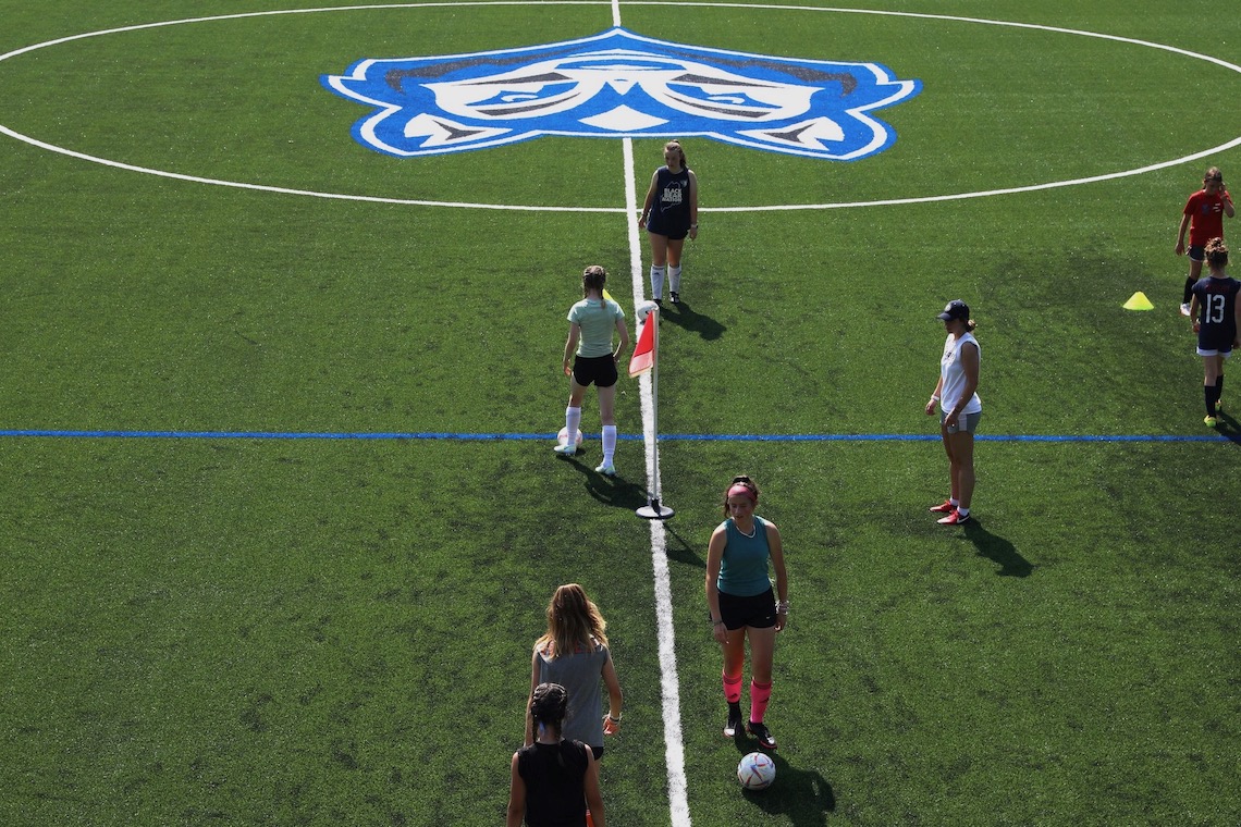 Girls soccer camp runs drills on new Hannaford Field turf.