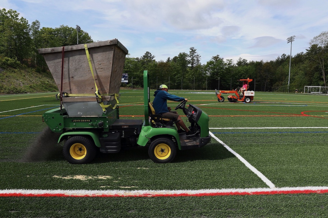 Infill spread and brushed into new Hannaford Field turf.