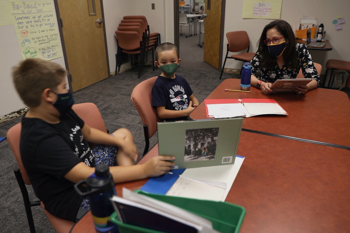 President Edmondson trades book recommendations with students in summer literacy class.