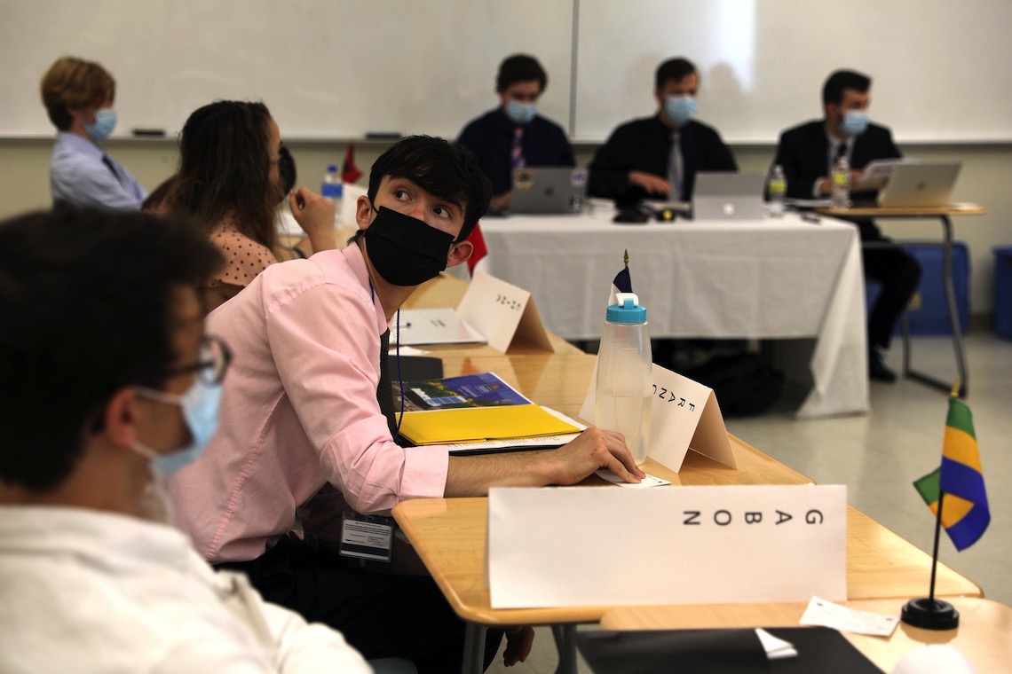 France's delegate checks the time during deliberations by MeMUNC's Security Council.
