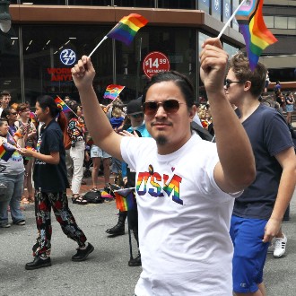 Students wave rainbow flags at 2022 Pride Portland! parade.