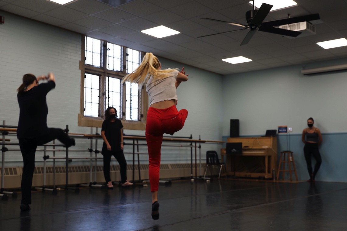 Dancers take flight while practicing routine during an open house for the Dance minor program.