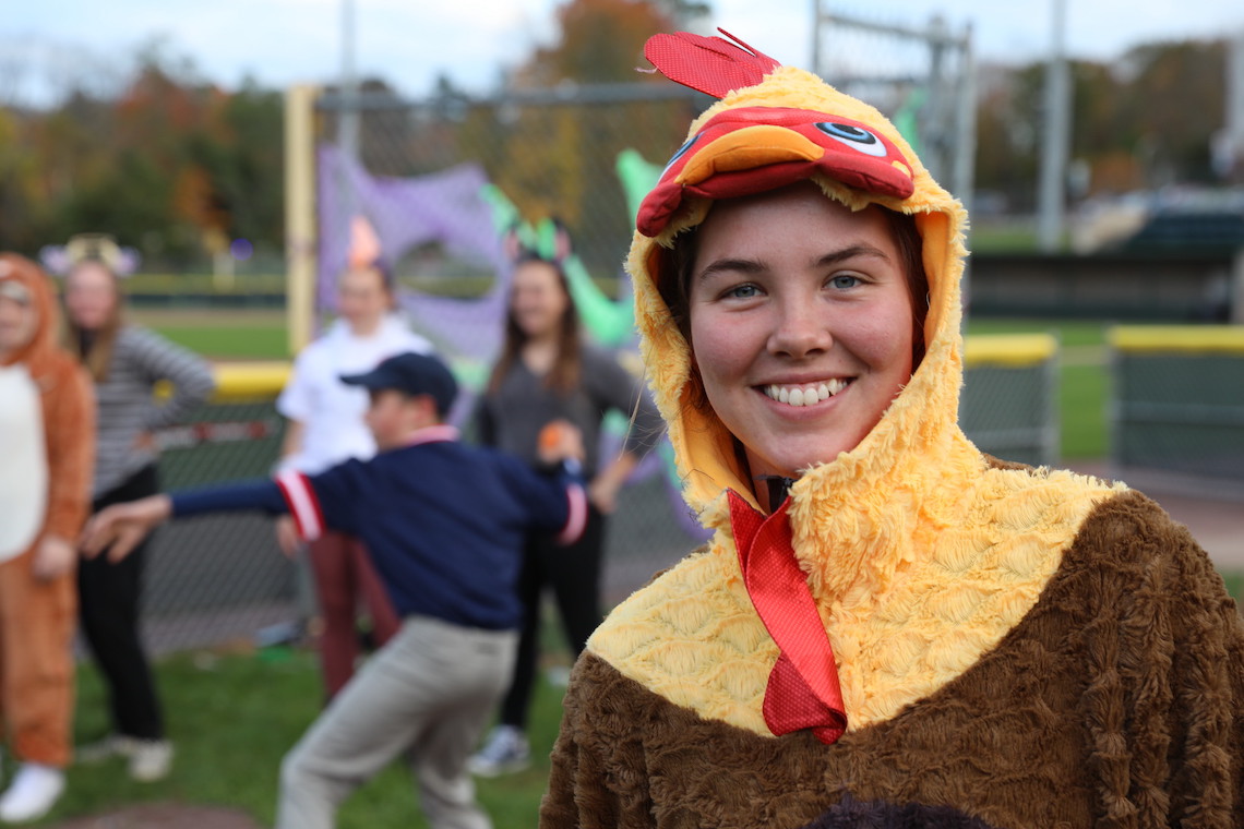 Student athletes offer trick-or-treaters pitching lessons and laughs at the Husky Community Halloween Party.