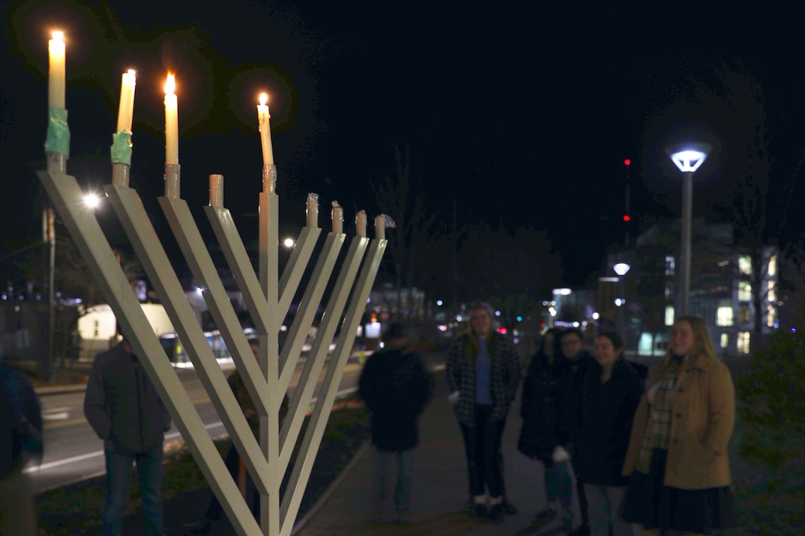 The lighting of the campus menorah is celebrated with the singing of traditional songs.