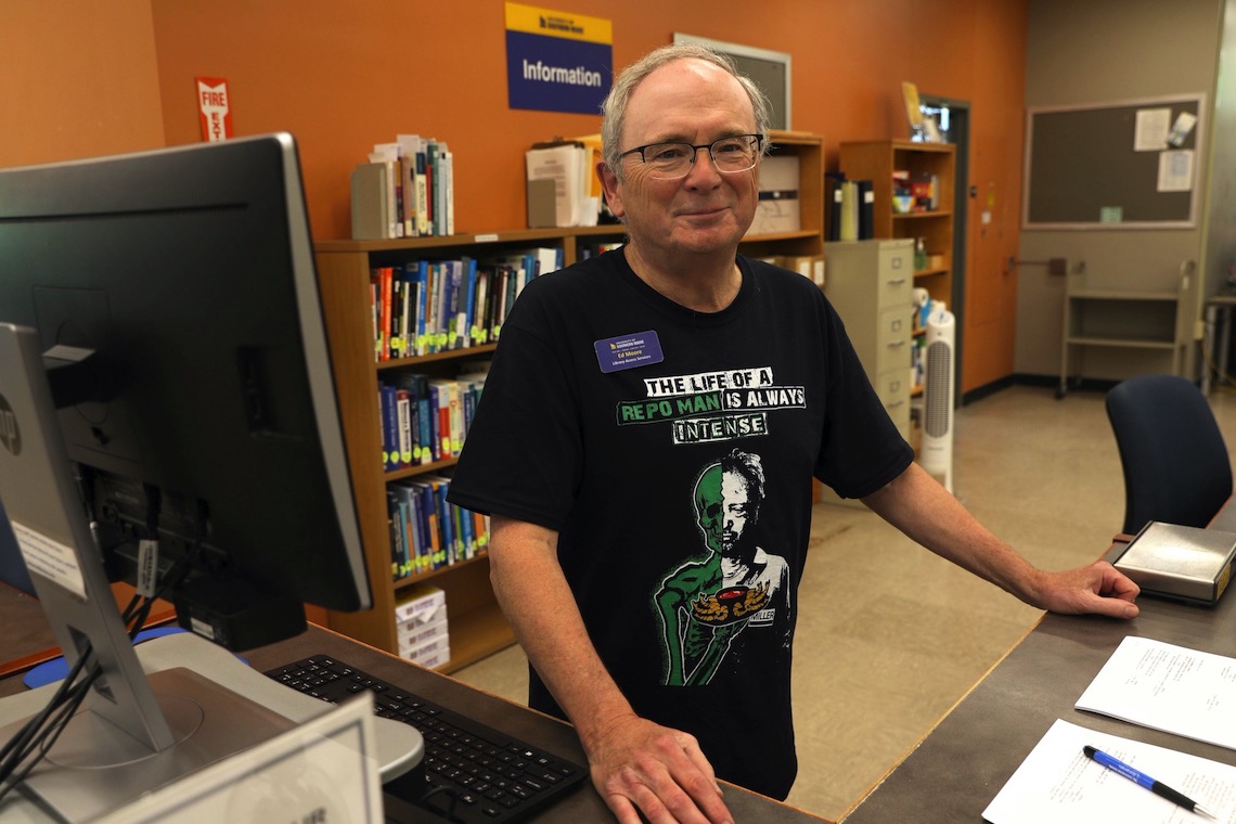 Ed Moore greets visitors to the Gorham Library from his post at the front desk.