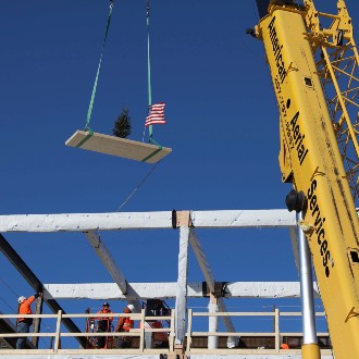 Topping-off ceremony celebrates installation of final panel in framework of the future Career & Student Success Center.