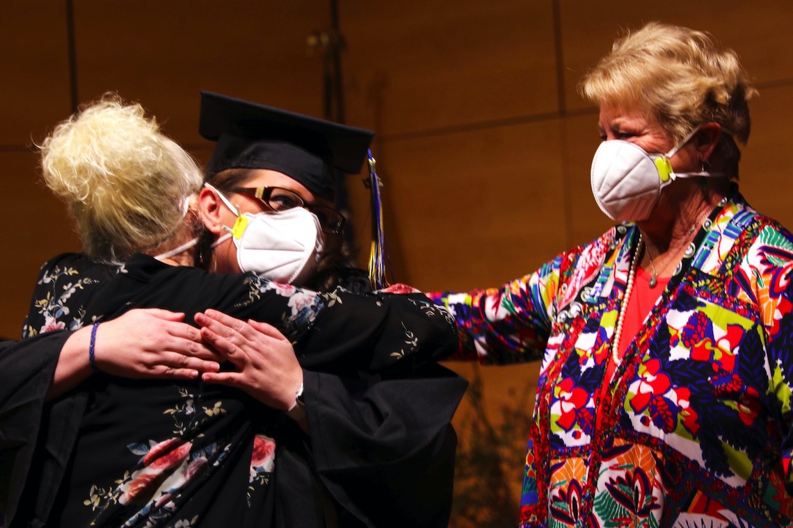 Family members joined graduates on stage at the fall 2021 Nursing Convocation.