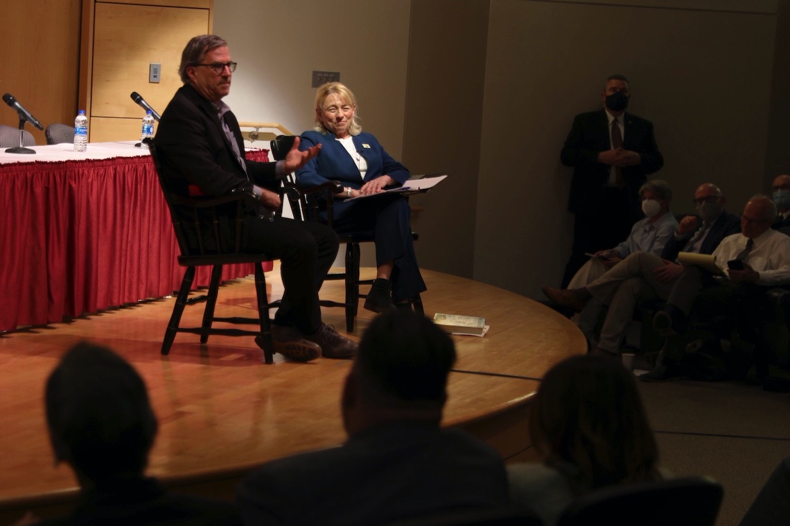 Gov. Janet Mills flashes a smile during an exchange with reporter Sam Quinones at a forum on the opioid epidemic.