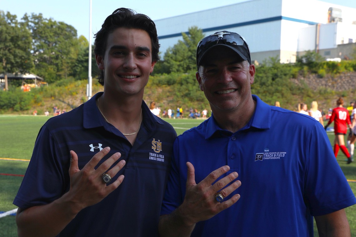 Ben Drummey and his father, Mike Drummey, flash matching national championship rings for pole vaulting.