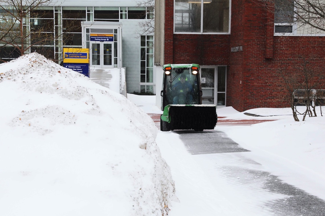 Following a Feb. 2022 snow storm, a sweeper removes sleet from a walkway in front of Luther Bonney Hall before it can harden into icy patches.