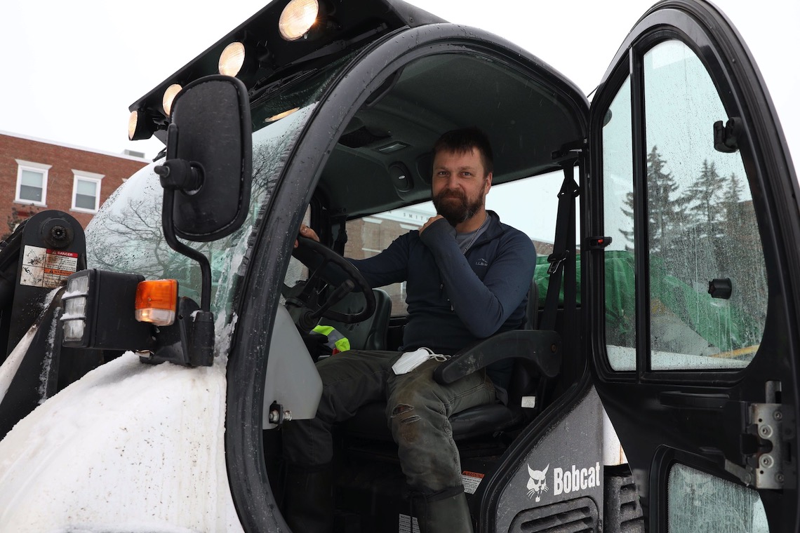 Christopher Bartlett takes a break from hours of snow removal work after a Feb. 2022 storm.