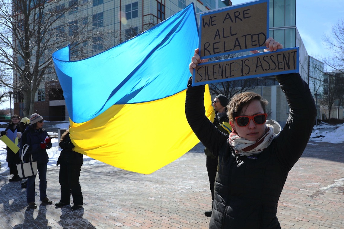 'We are all related, silence is assent,' reads a sign at a pro-Ukraine demonstration outside Glickman Library.