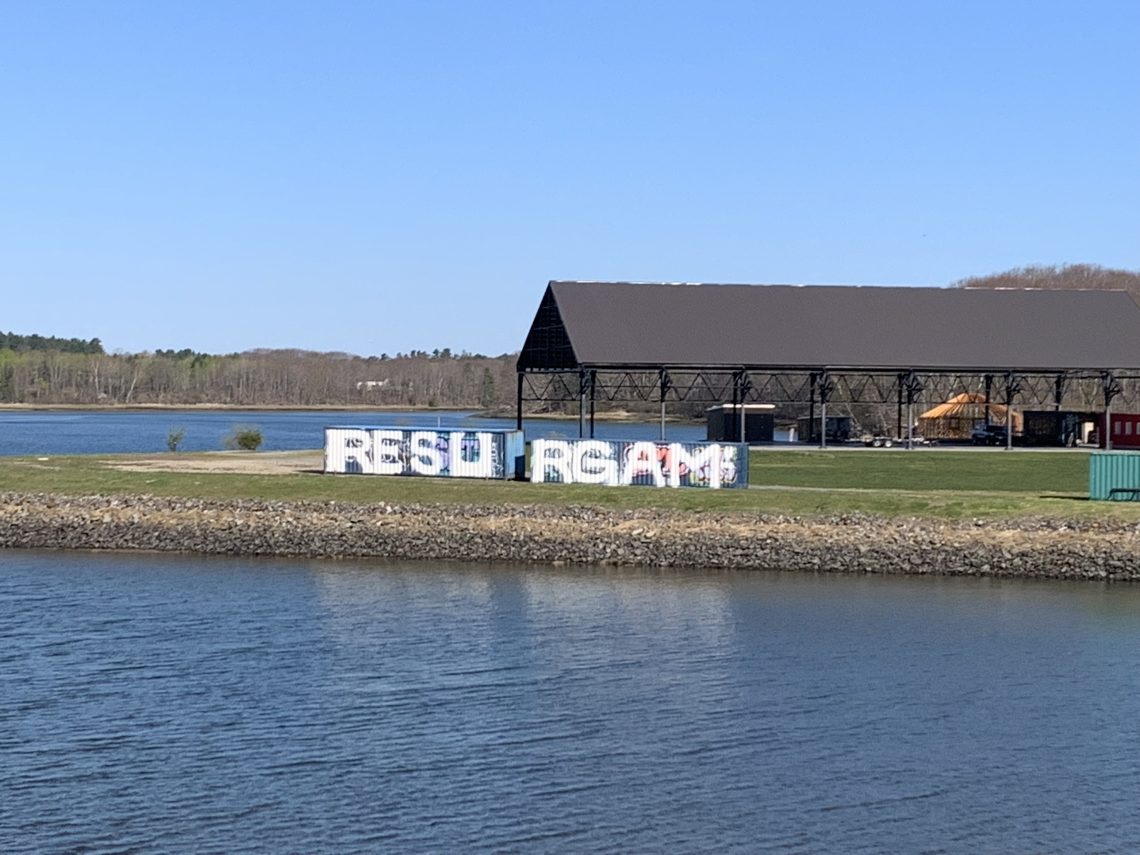 "RESURGAM" spray painted on large shipping containers on Thompson's Point, Portland, Maine.