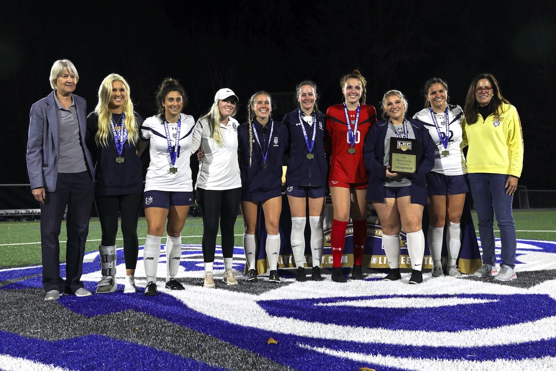 Members of the women's soccer team show off their awards after defeating WestConn to win the Little East Conference Championship.