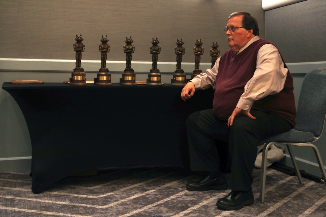 Director of Athletics Al Bean keeps watch over the 2022 Husky Hall of Fame trophies.