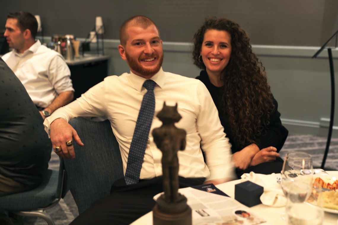 Wrestler Dan Del Gallo unwinds at his table after being inducted into the 2022 Husky Hall of Fame.