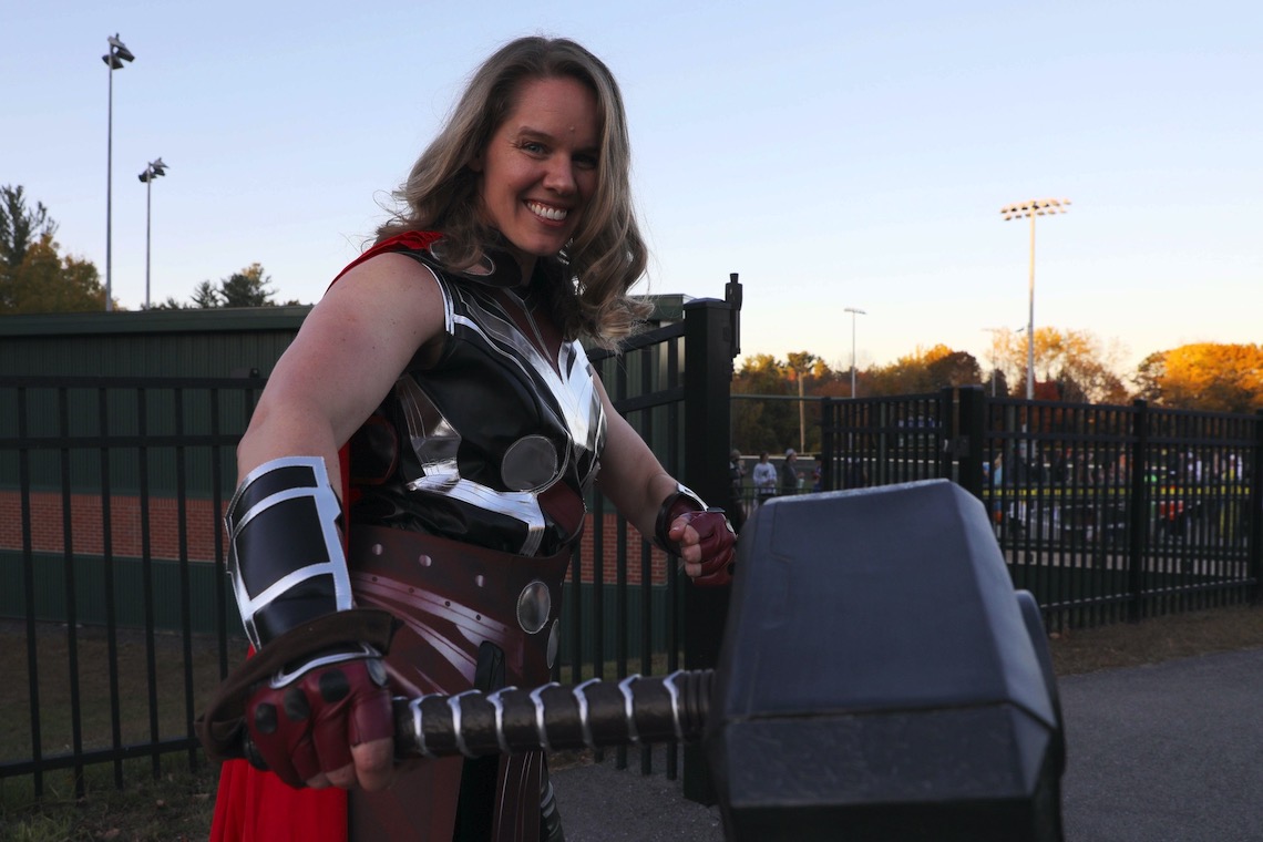 Women's Basketball Head Coach Samantha Norris swings a mean hammer in her guise as the Mighty Thor at the Husky Halloween event.
