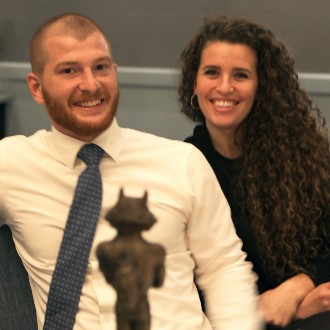 Wrestler Dan Del Gallo enjoys the view of his trophy after being inducted into the Husky Hall of Fame.