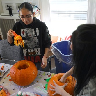 Erika Santillanes chose the right tool when she picked a serrated scoop to clean out her pumpkin at TRIO's jack-o-lantern carving workshop.