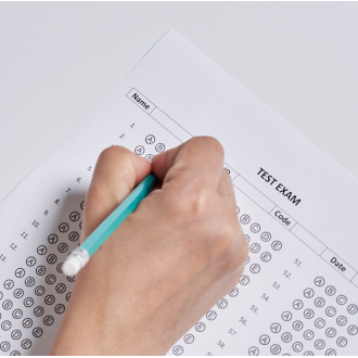 Pencil in hand taking a multiple choice exam
