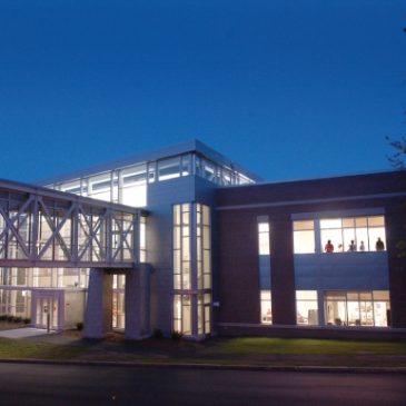 The Abromson Community Education Center lit up at night.