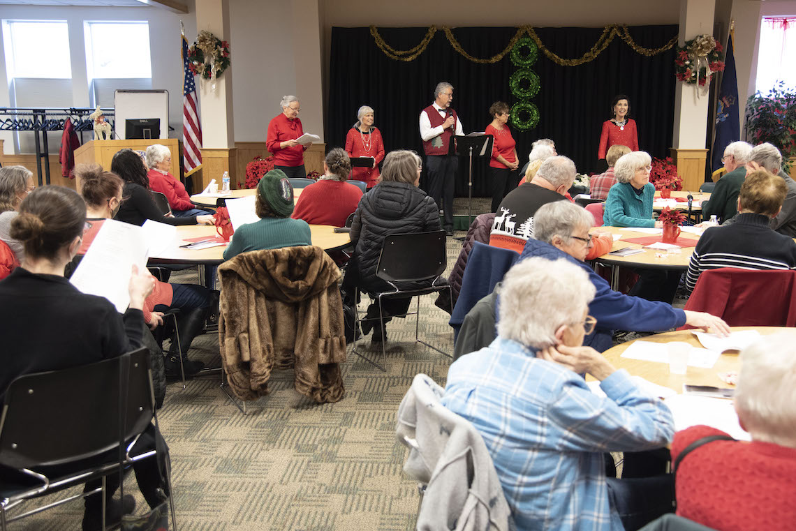 Members of Les Troubadours reunite to perform Christmas carols in French at a sing along hosted by the Franco-American Collection.