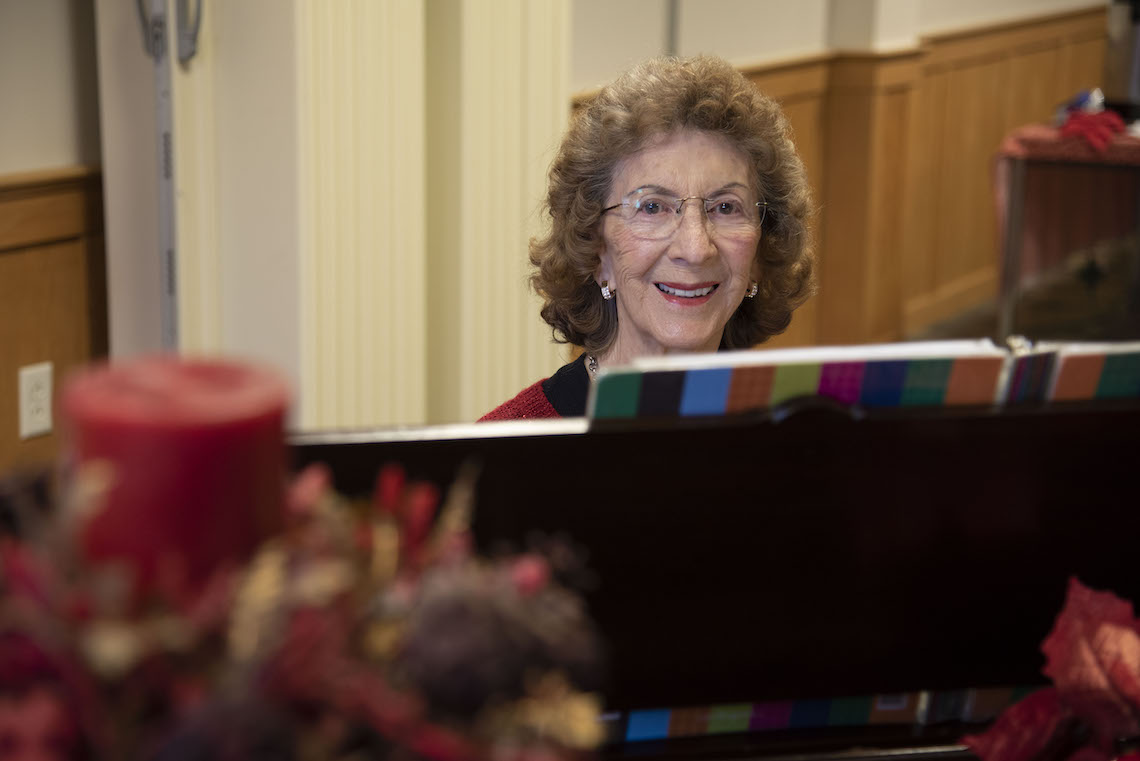 At 91 years old, Jeannette Gregoire provides piano accompaniment at a French language sing along of Christmas carols, hosted by the Franco-American Collection.