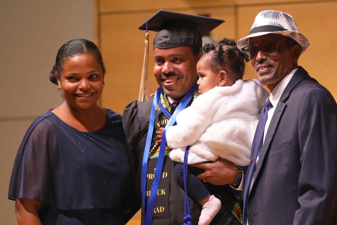 A graduate and his family celebrate the completion of his degree at the December 2022 Nursing Convocation ceremony.