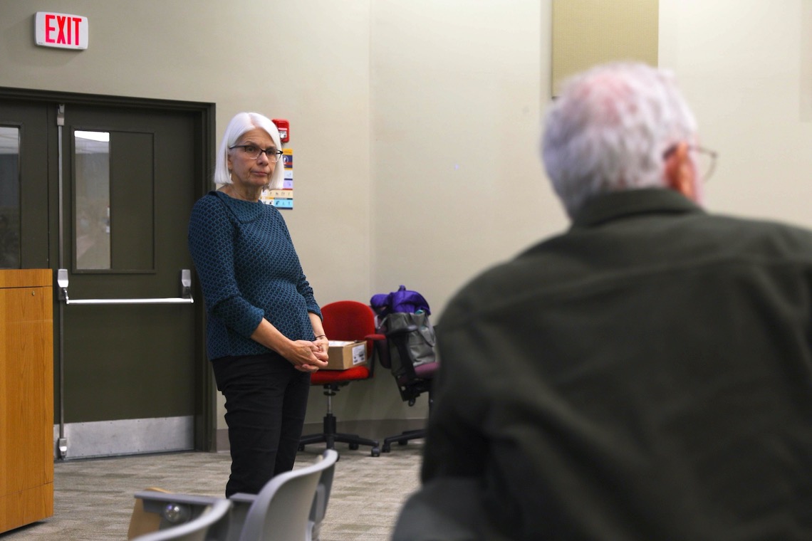 Alison Jones Webb listens to a question from the audience during a lecture about her book, "Recovery Allies."