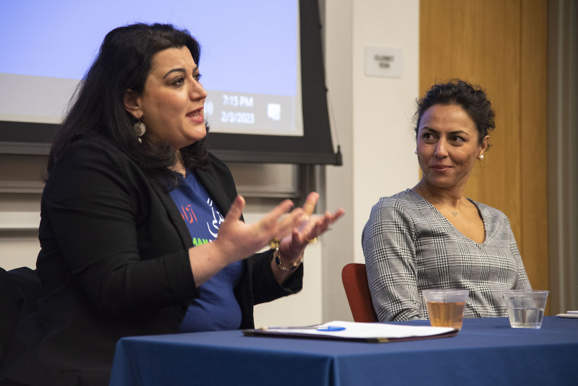 Dr. Rojin Mansouri listens as Roya Hejabian speaks during a panel discussion about protests in Iran.