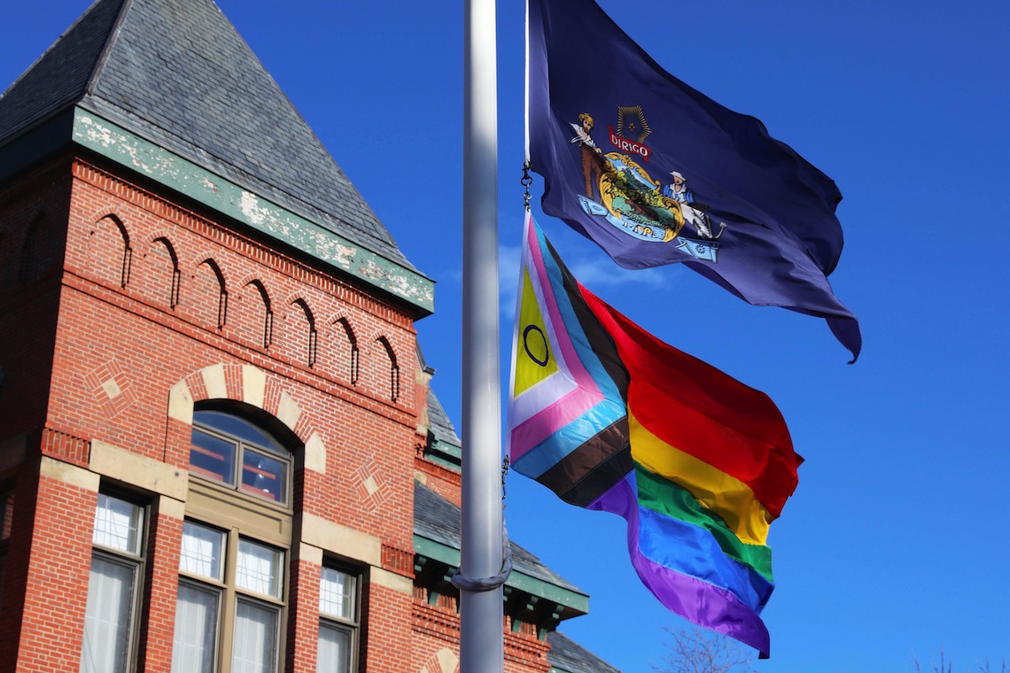 The Maine state flag and the Intersex-Inclusive Progress Pride Flag fly in tandem outside of Corthell Hall.