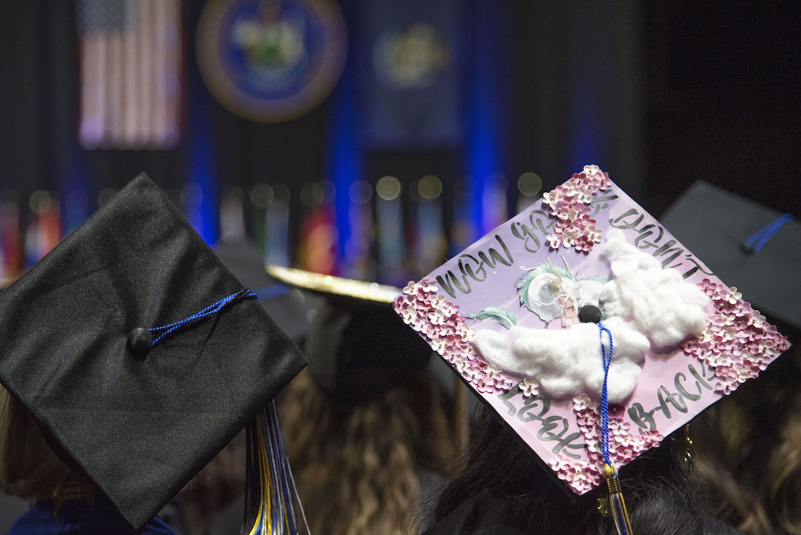 The words "Now go, don't look back" are written on the cap of a graduate at the 2023 Commencement.