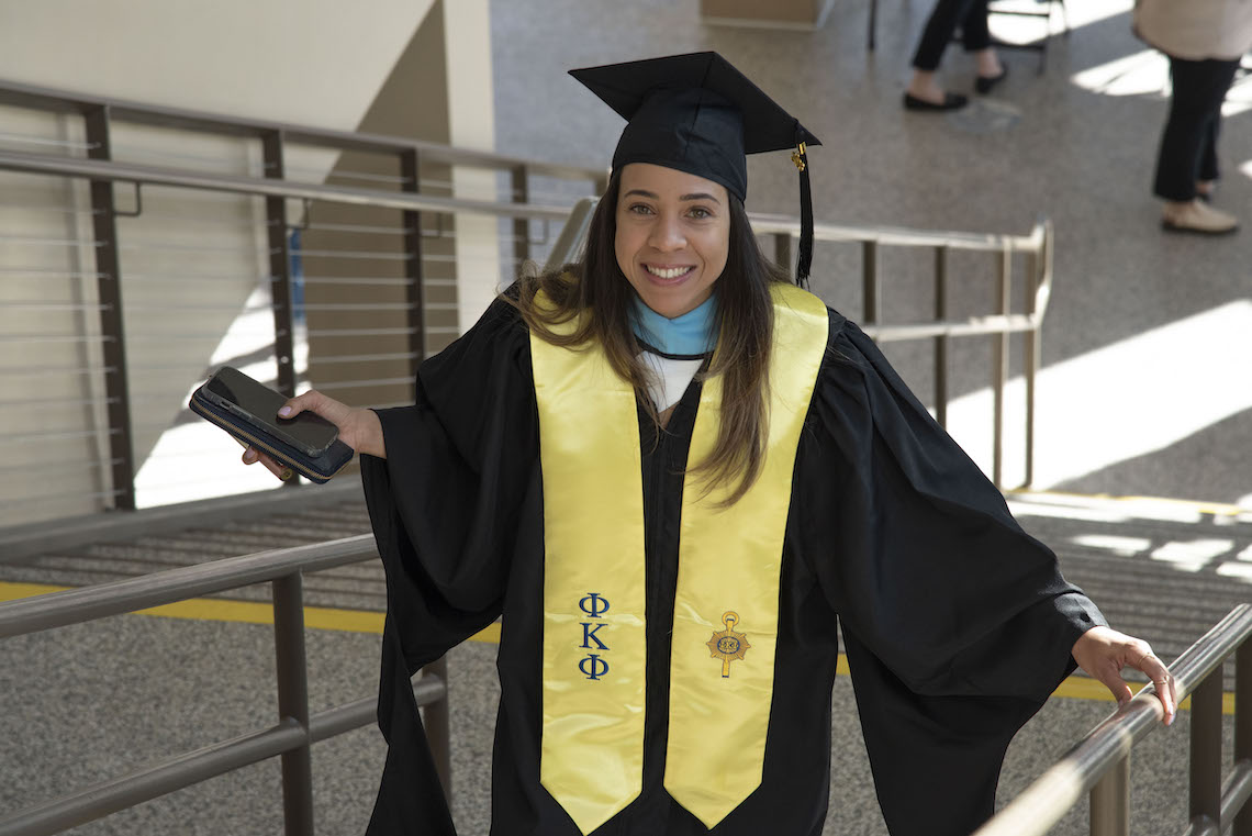 A smile reflected the happy mood as a student enters the Cross Insurance Arena in Portland ahead of the 2023 Commencement.