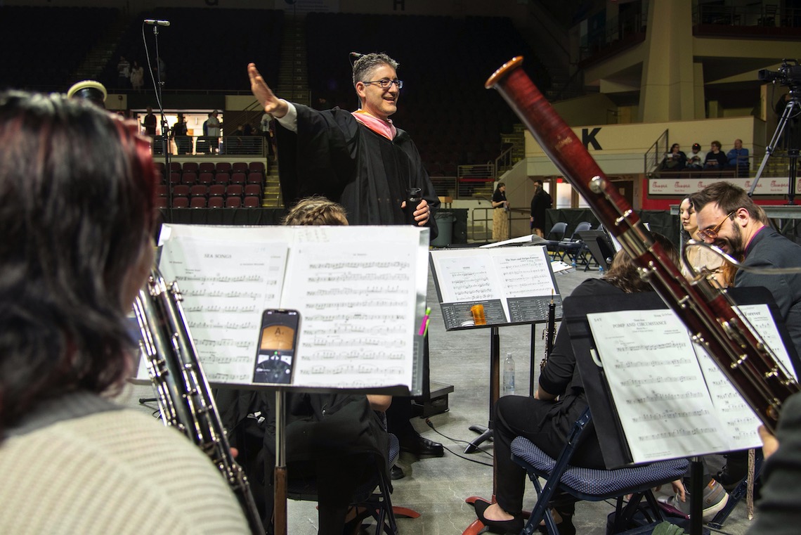 Dr. William Kinne conducts the band that provides the music for the 2023 Commencement.