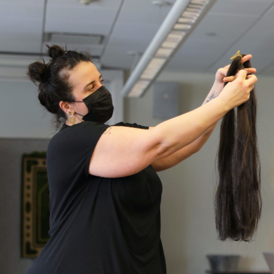 Artist-in-residence Veronica Perez readies a strand of hair for braiding as she gathers materials for her exhibition at the USM Art Gallery.