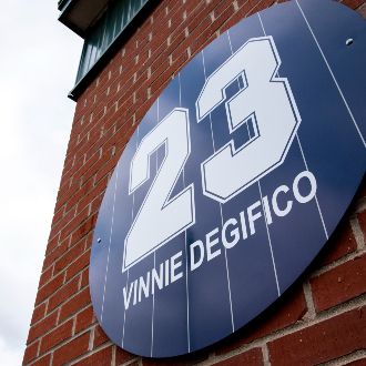 A sign featuring Vinnie Degifico's newly retired number overlooks Flaherty Field.