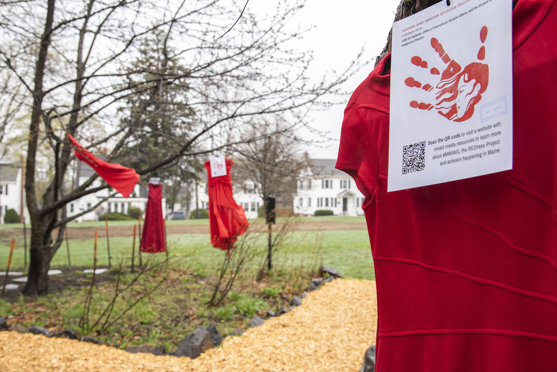 Several dresses decorate the field outside Luther Bonney Hall as part of the REDress Project.