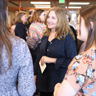 Dr. Jeanette Andonian speaks with students at the Commencement Celebration