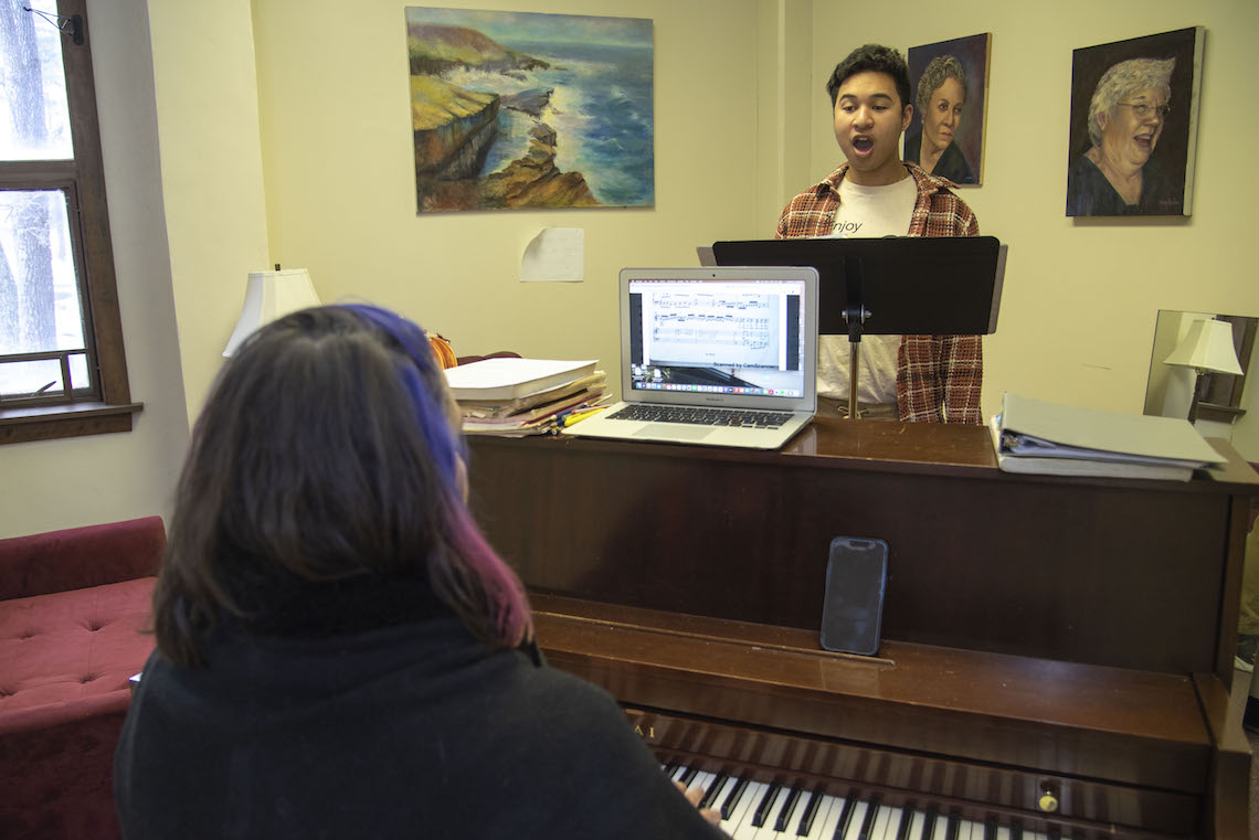 Alexandra Dietrich accompanies Dylan Cao on the piano as she leads him in a voice lesson at Corthell Hall in Gorham.
