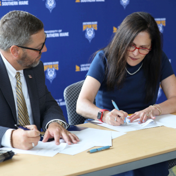 USM President Jacqueline Edmondson and SMCC President Joe Cassidy sign the Southern Maine Pathway agreement strengthening bonds between the two institutions.