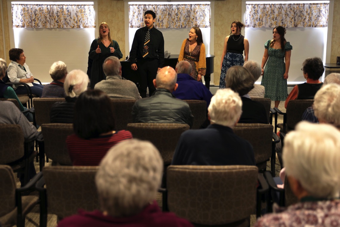 Visiting opera singer Megan Marino and several students join voices in a performance for residents of OceanView at Falmouth.