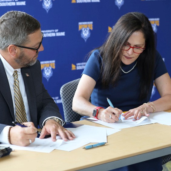 USM President Jacqueline Edmondson and SMCC President Joe Cassidy sign the Maine Pathways agreement.