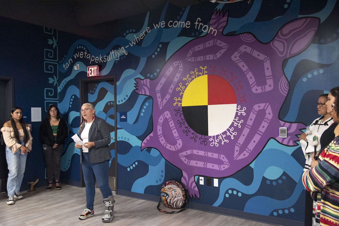 Speakers took turns explaining how they felt to see a new mural unveiled a the McGoldrick Center.