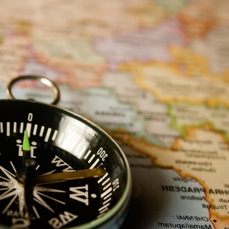 A compass resting on a zoomed in world map