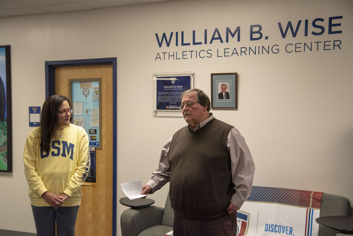 Athletic Director Al Bean draws attention to the plaque and portrait honoring the man for whom the William B. Wise Athletics Learning Center was named.