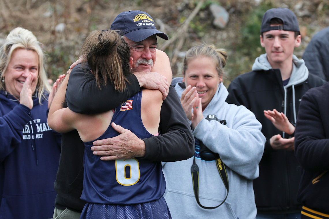 Hannah Banks hugs her father, Mike, after leading the field hockey team to victory in the LEC championship game.